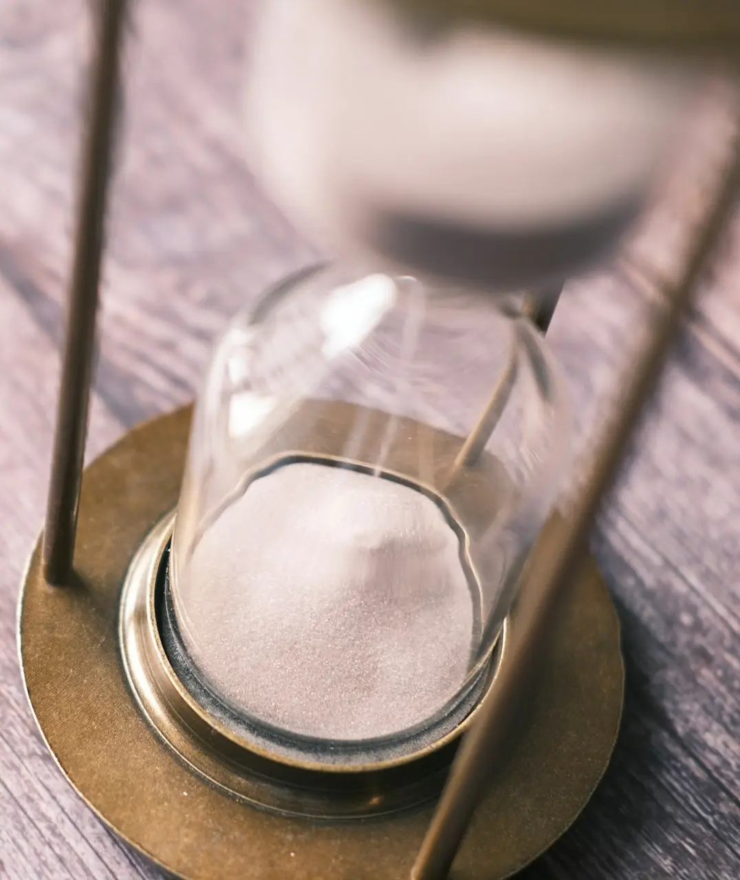 an hourglass sitting on top of a wooden table